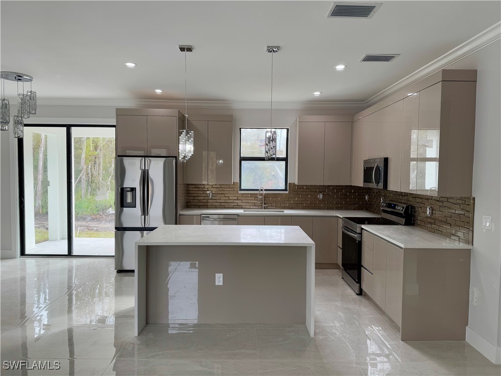 a kitchen with kitchen island a sink stainless steel appliances and cabinets