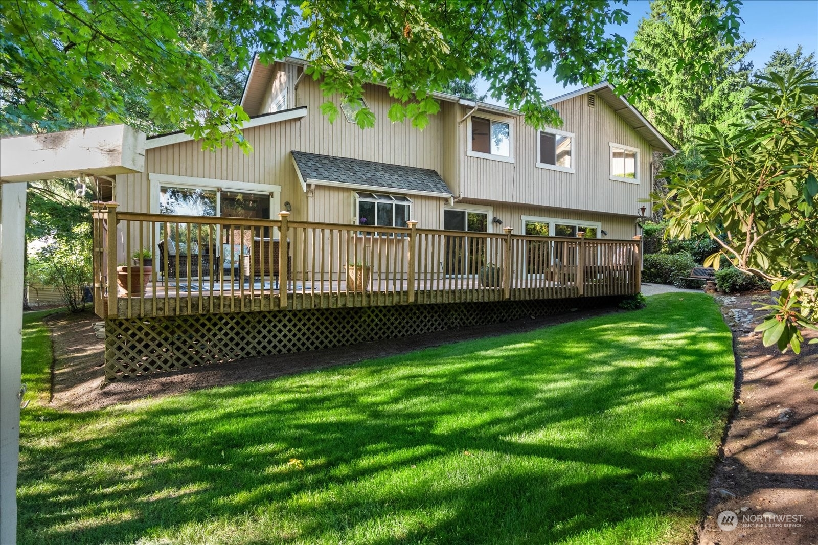 a view of a house with a yard and a garden