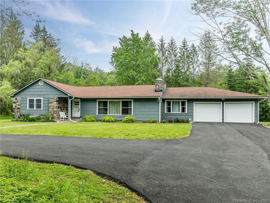 a front view of a house with a yard and pathway