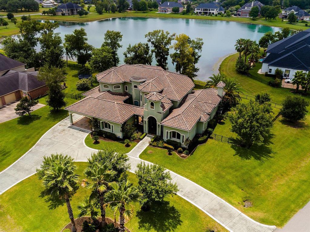 an aerial view of a house with swimming pool and outdoor space