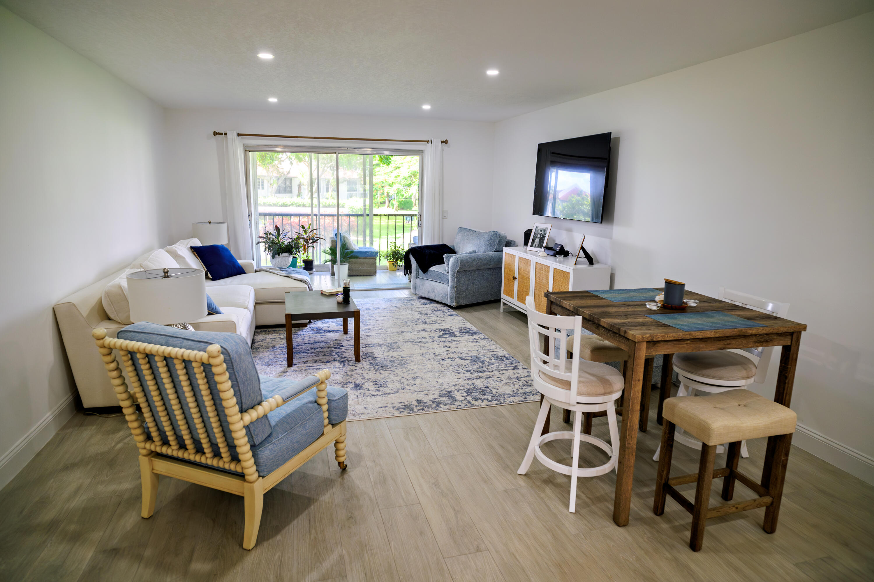 a dining room with furniture and wooden floor