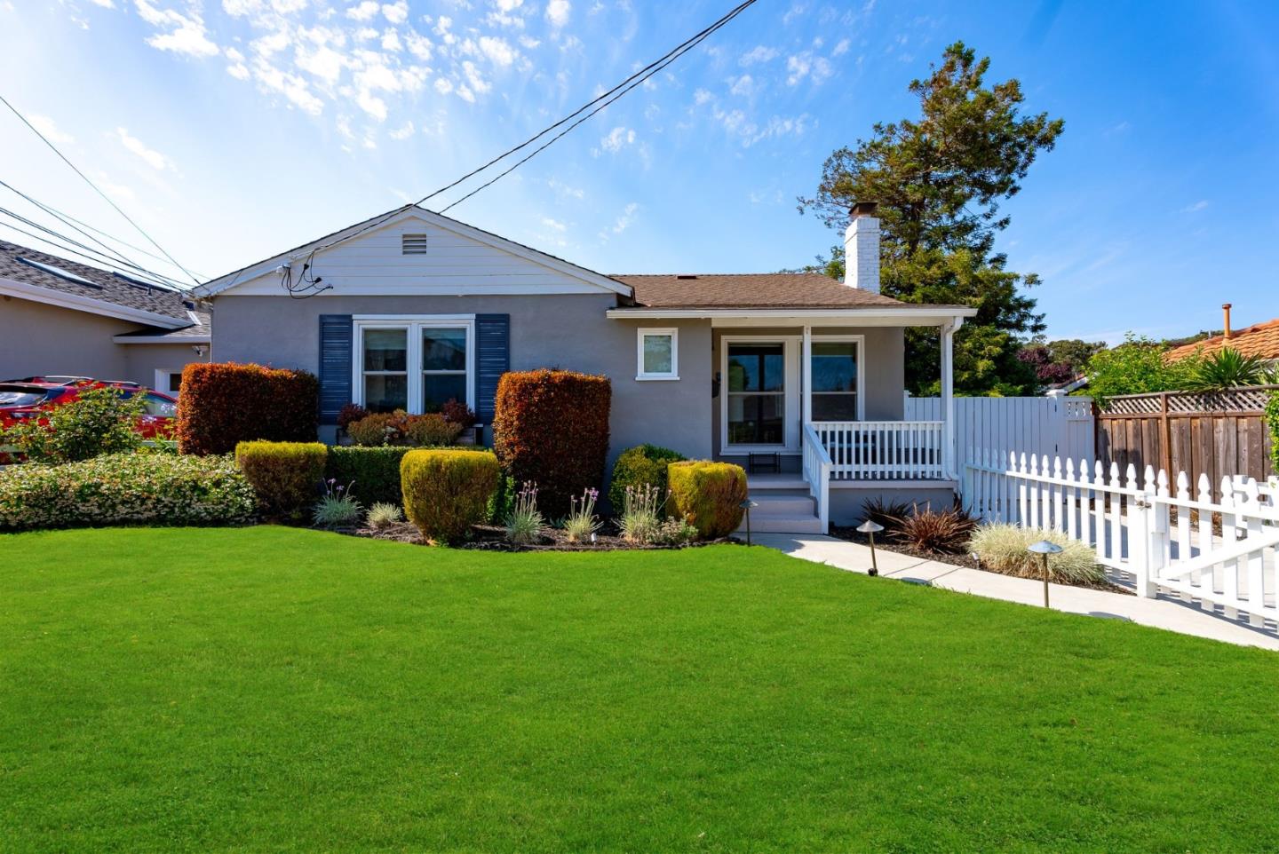 a front view of a house with garden and porch