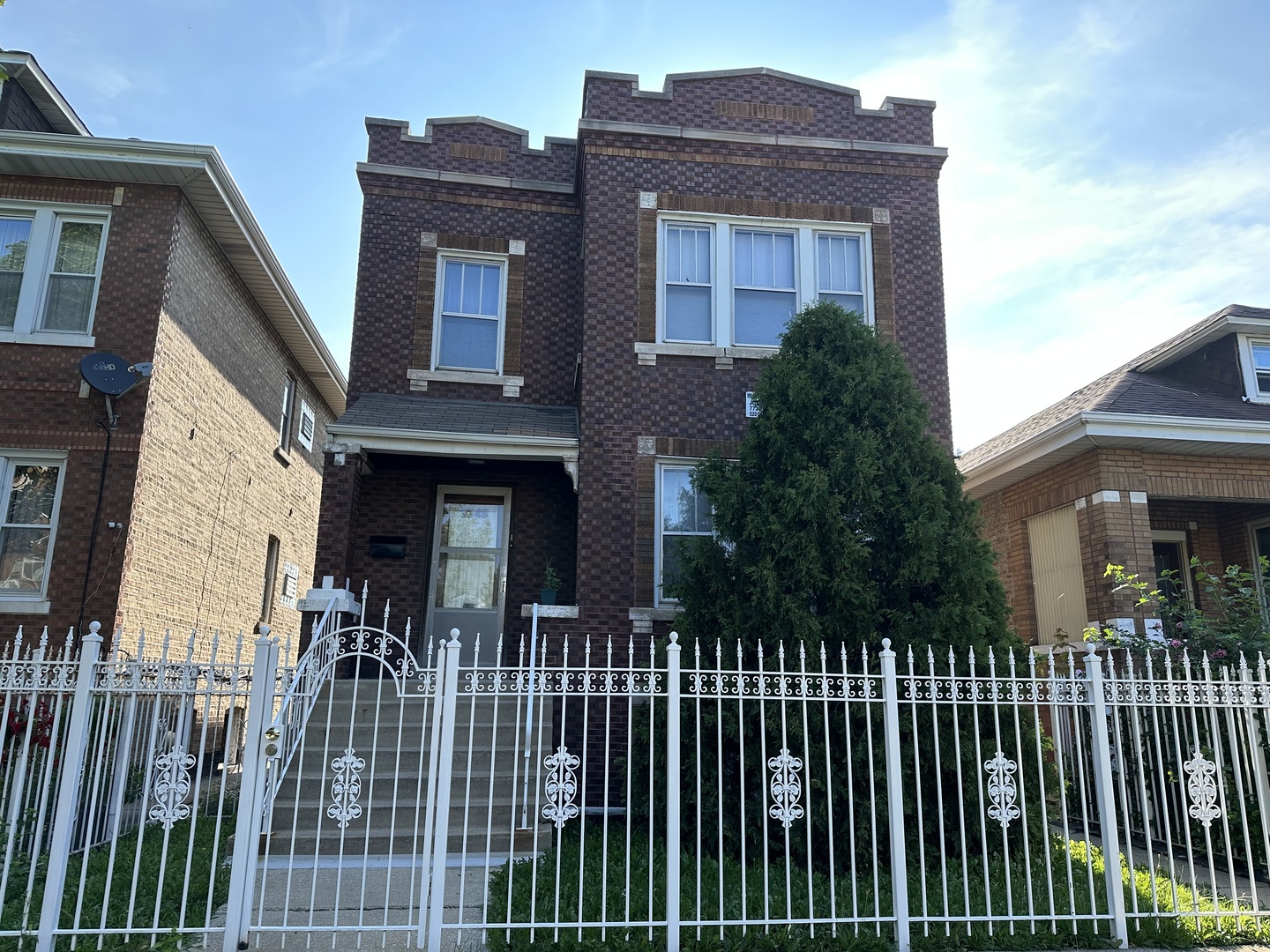 a view of a brick house with large windows