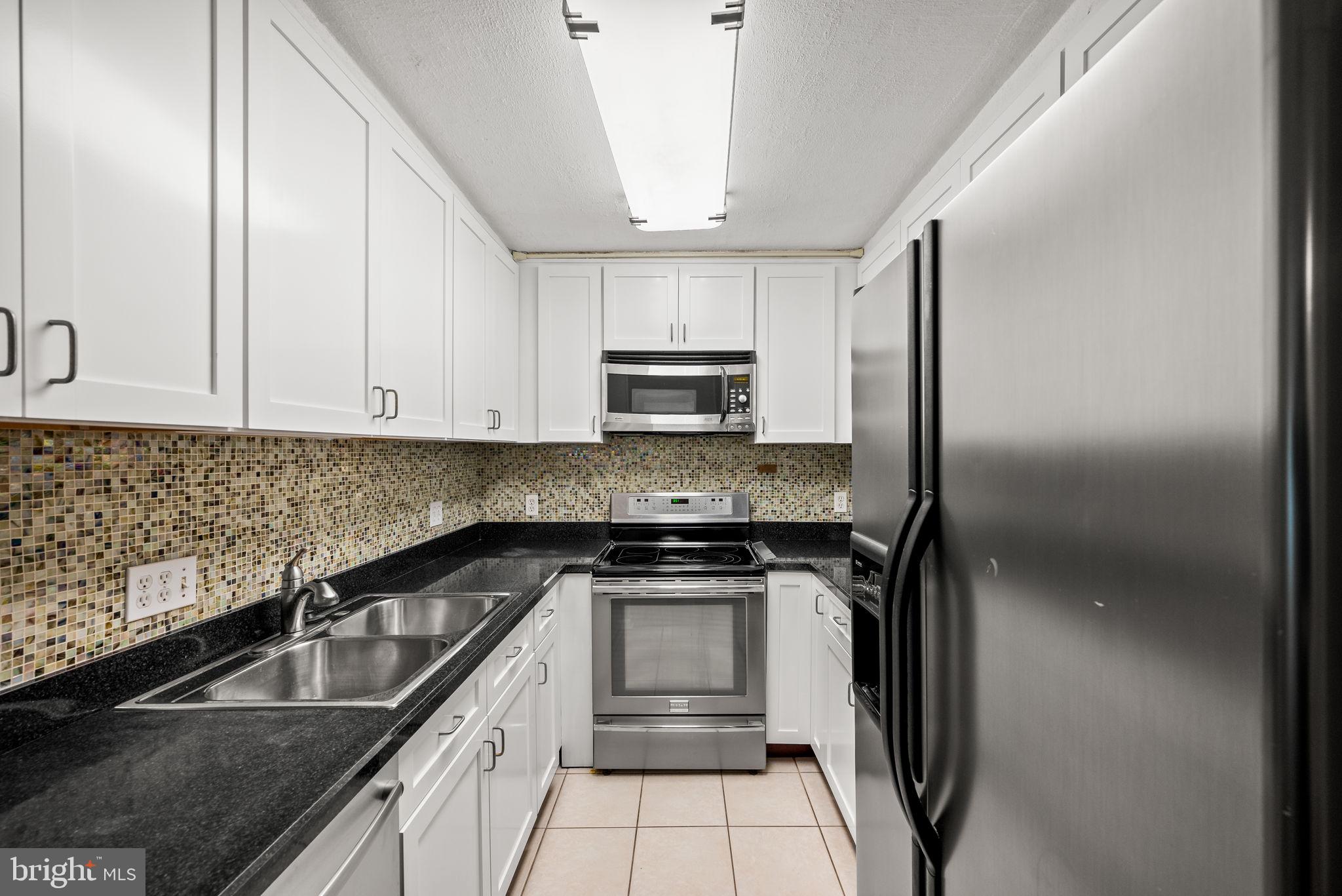 a kitchen with a sink stove and refrigerator