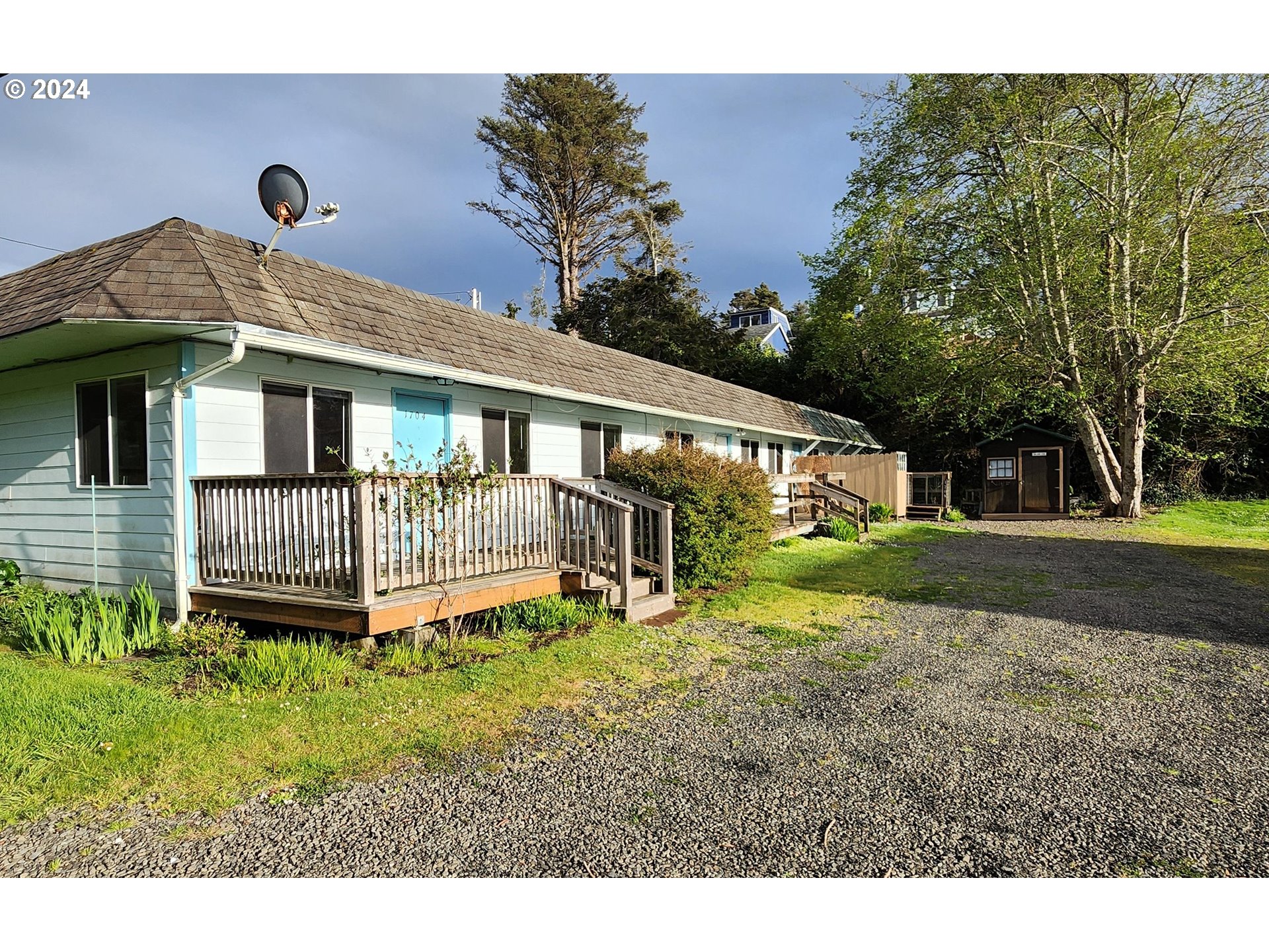 a view of a house with a yard and deck