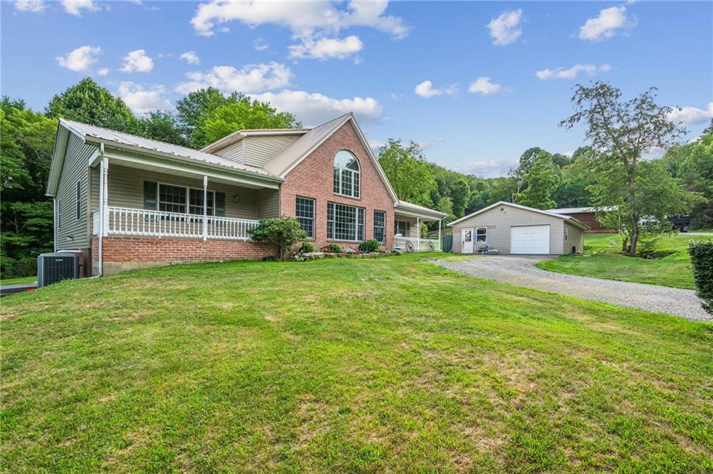 a front view of house with yard and green space