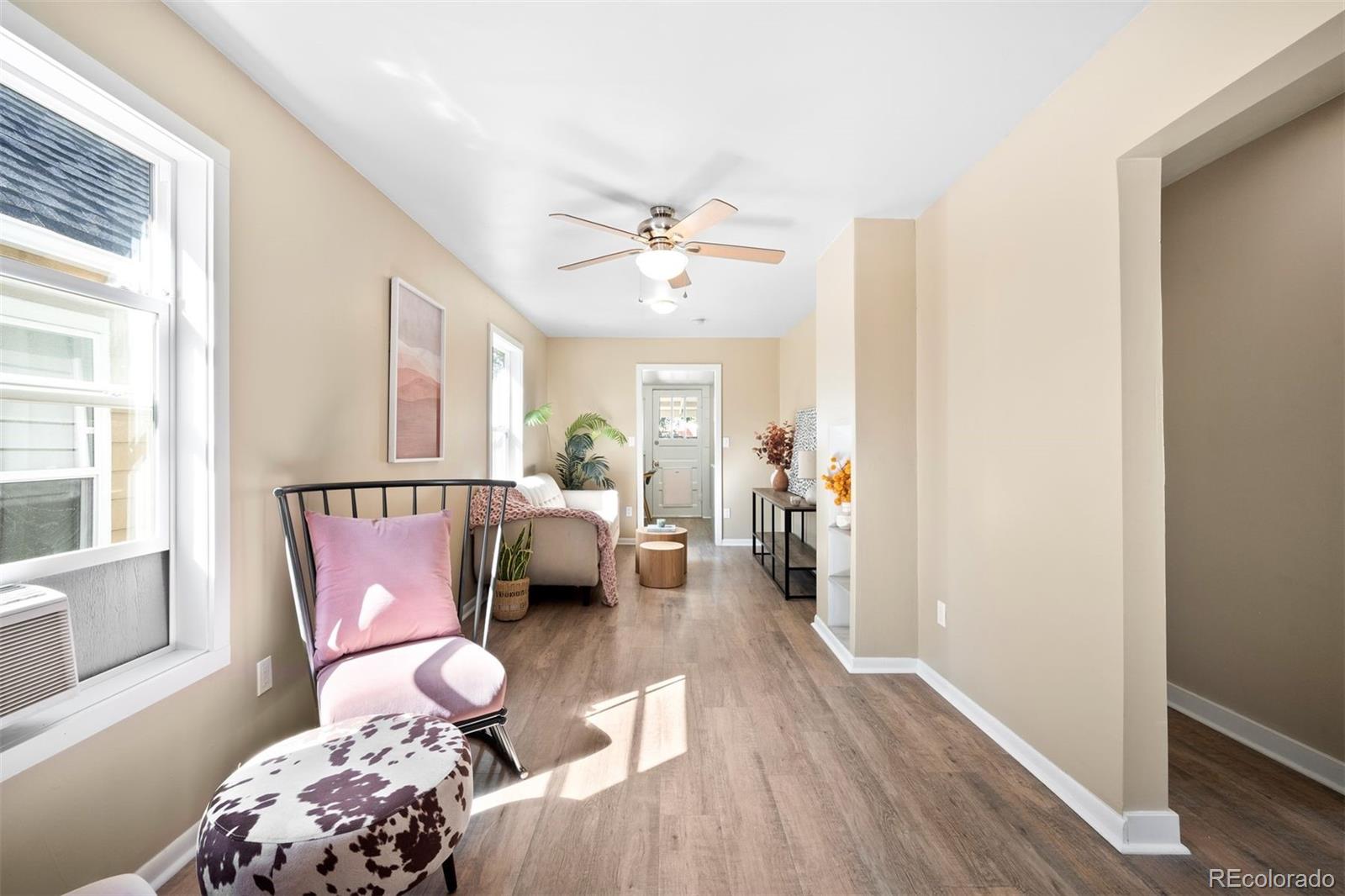 a living room with furniture and wooden floor