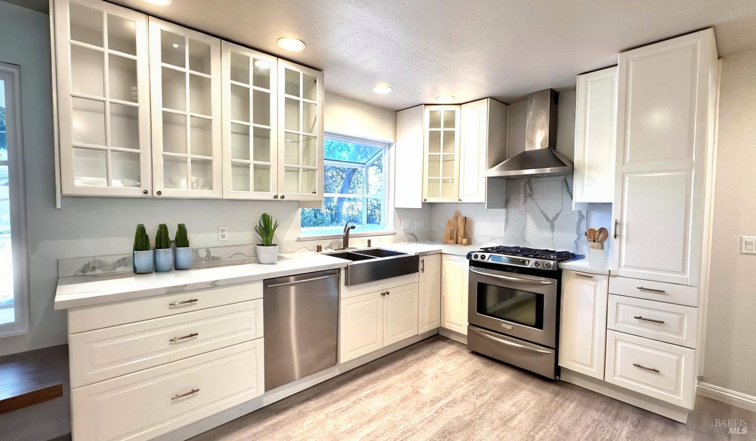 a kitchen with stainless steel appliances granite countertop a stove and a sink