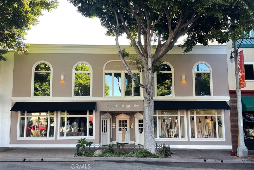 a front view of building with trees