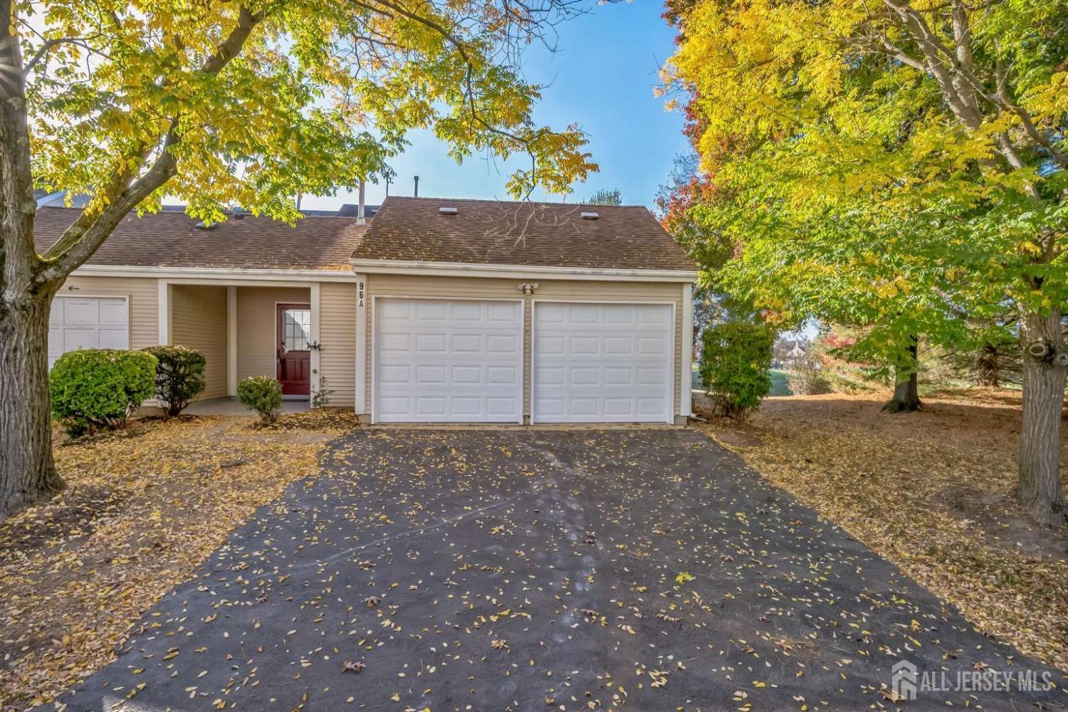 a view of a house with a yard and garage