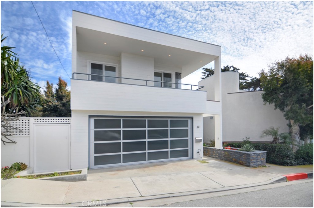 a view of house with outdoor space and parking