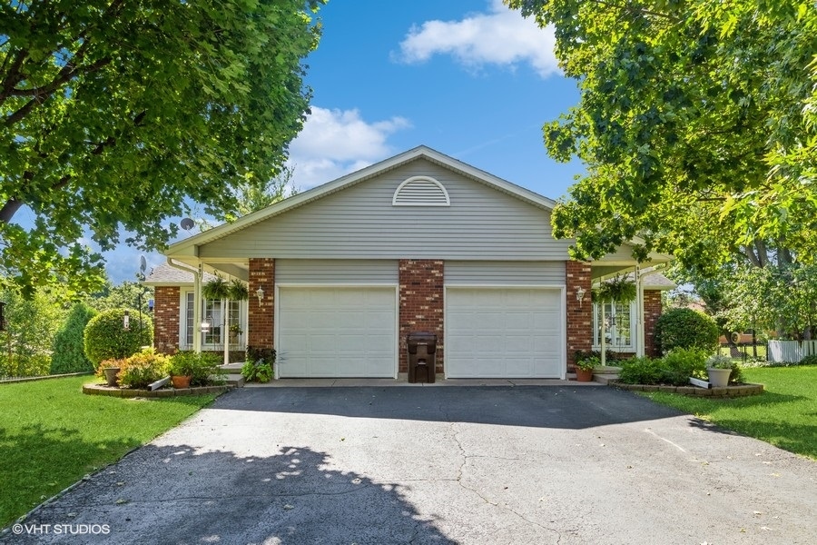 a front view of house with yard and trees