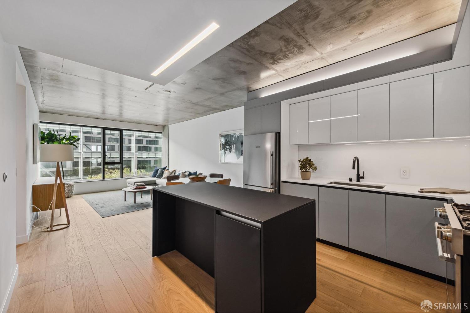 a kitchen with stainless steel appliances a sink stove and cabinets