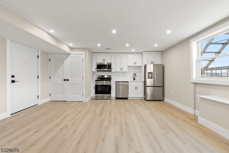 a view of kitchen with refrigerator stove microwave and cabinets