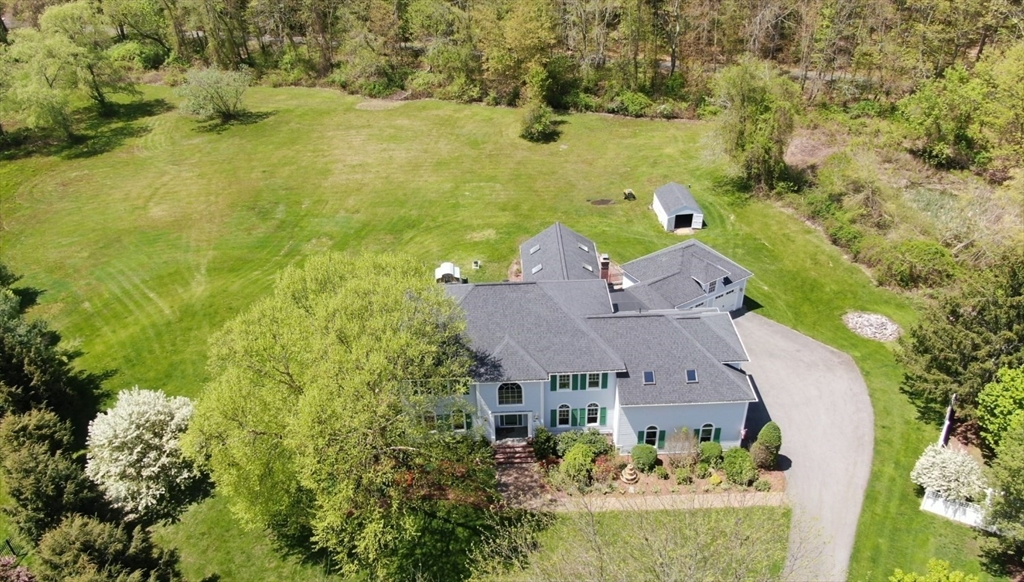 an aerial view of house with yard swimming pool and outdoor seating