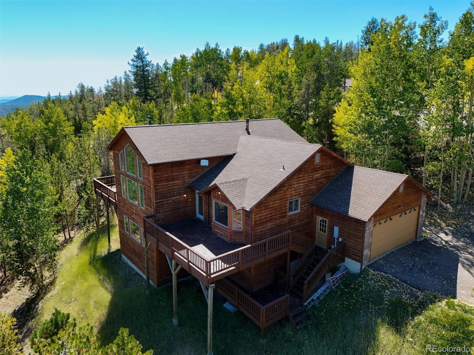 an aerial view of a house with swimming pool and big yard