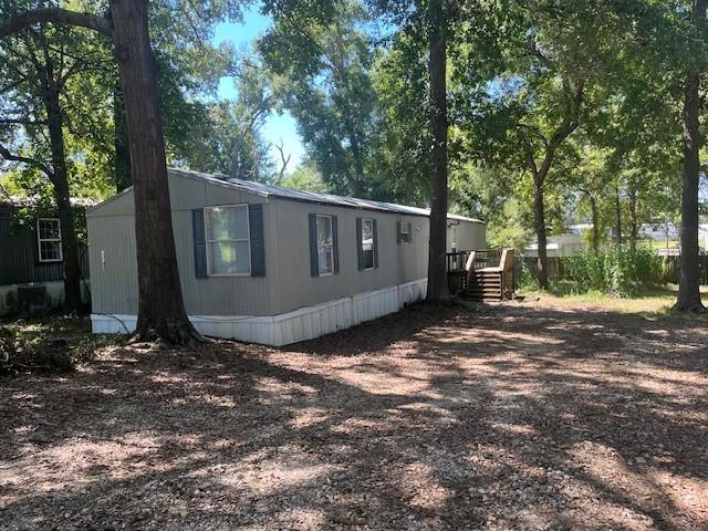 a view of backyard with tub and trees