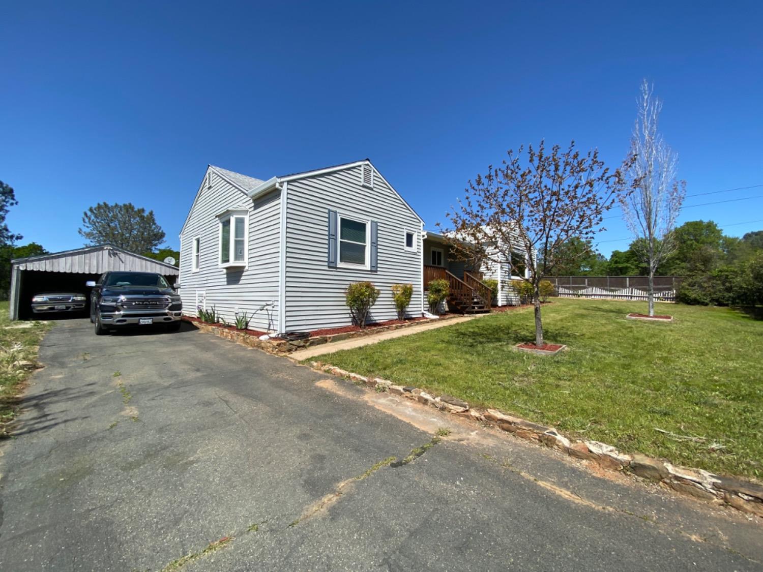 a car parked in front of a house with a yard