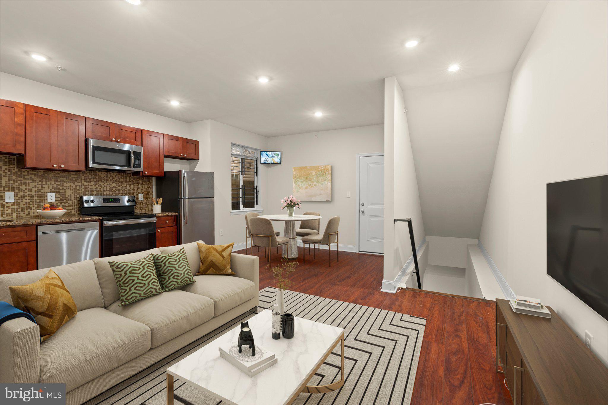 a living room with furniture and a wooden floor