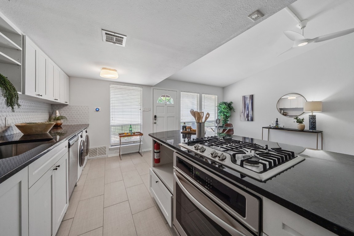 a kitchen with a stove and a sink