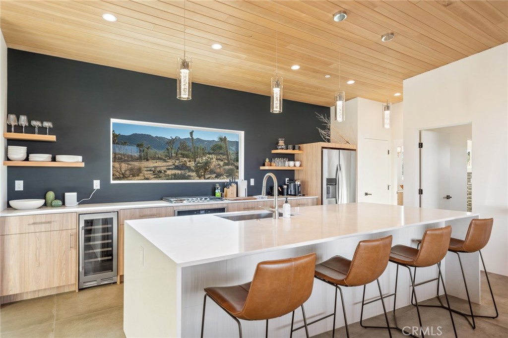 a kitchen with stainless steel appliances kitchen island granite countertop a sink and cabinets