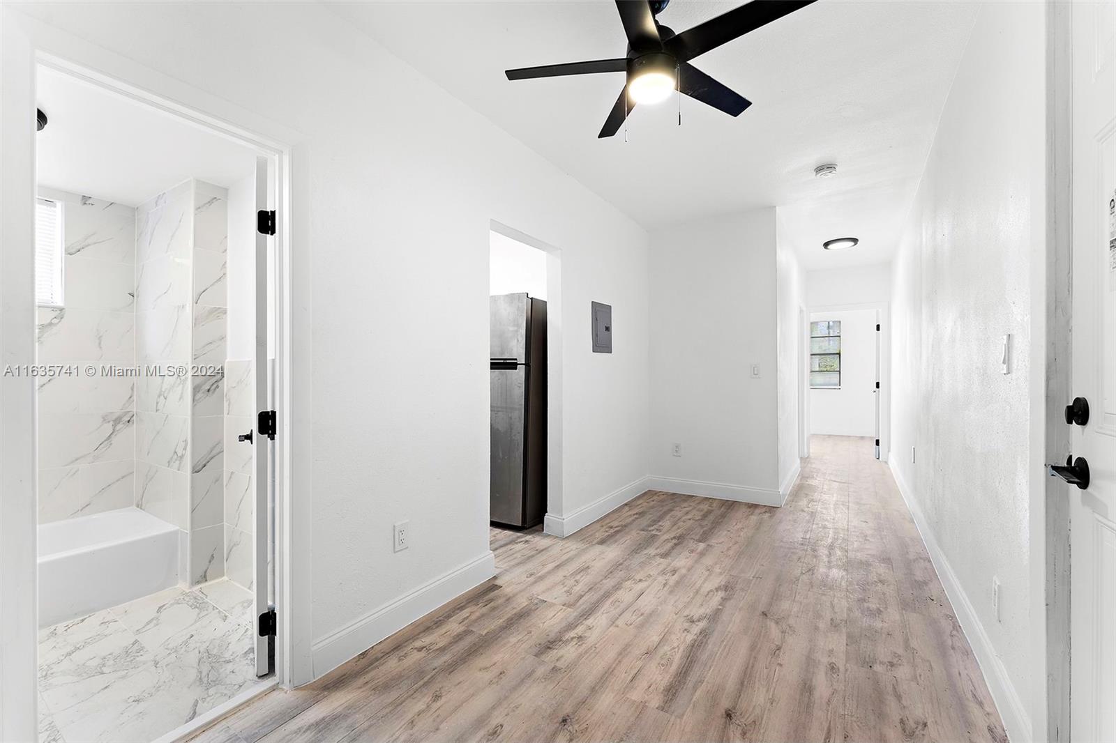 a view of hallway with wooden floor