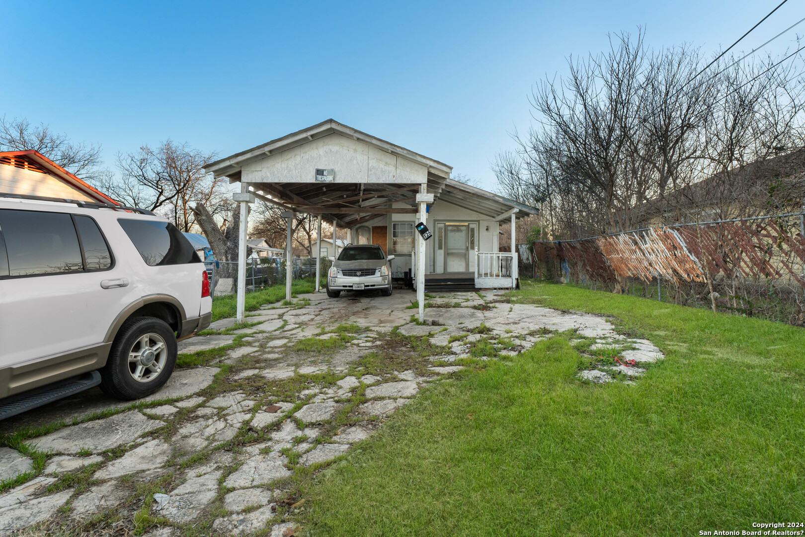 a view of a house with truck parked on the side of the house