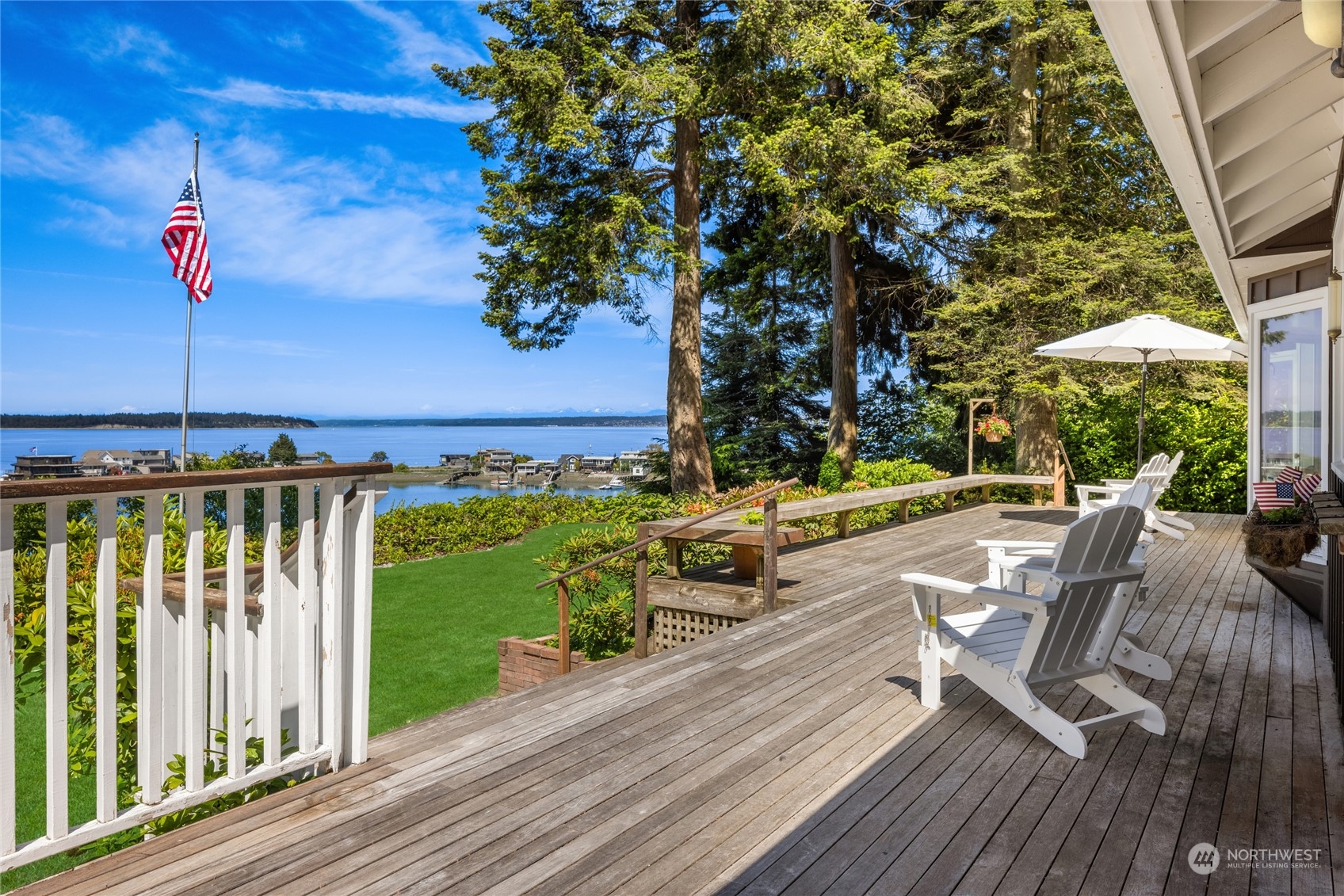 a view of a patio with table and chairs with wooden floor and fence