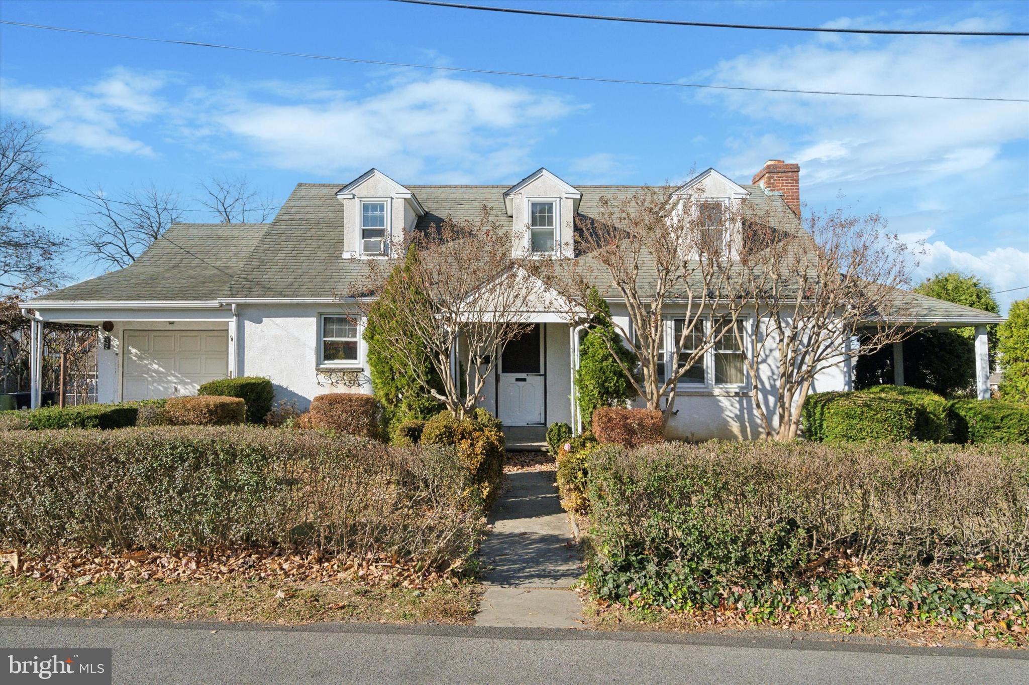 a front view of house with yard space and seating