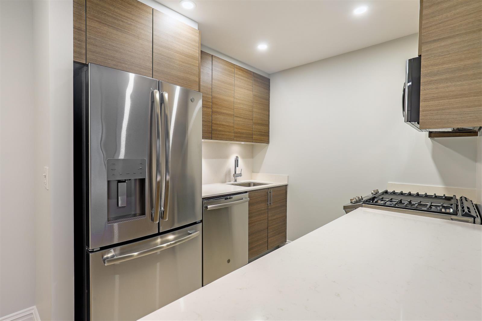 a kitchen with stainless steel appliances a refrigerator and a sink