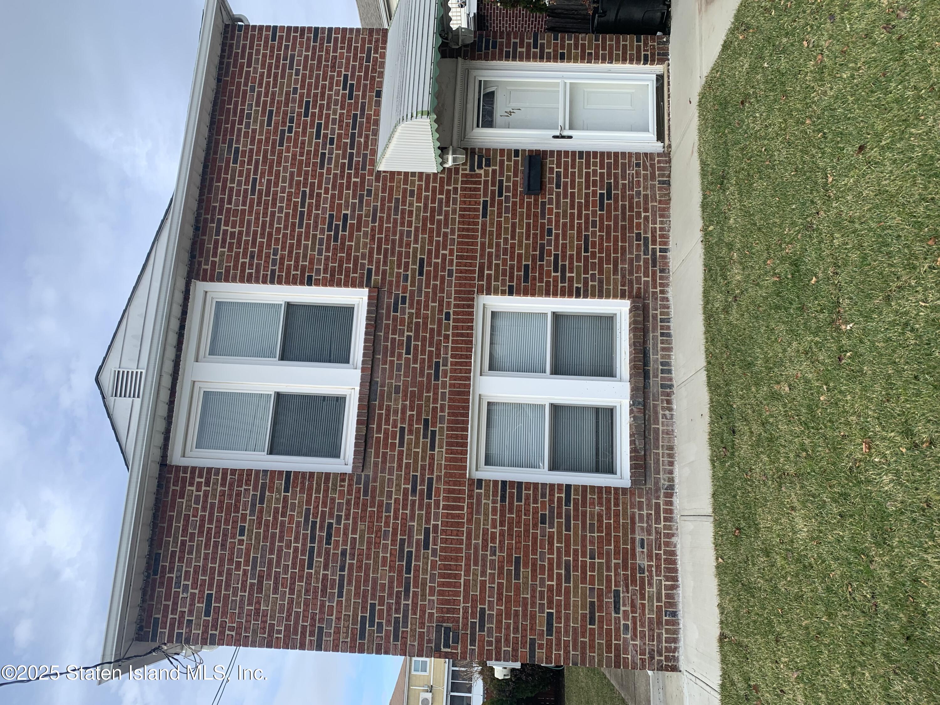 a brick house with a large windows