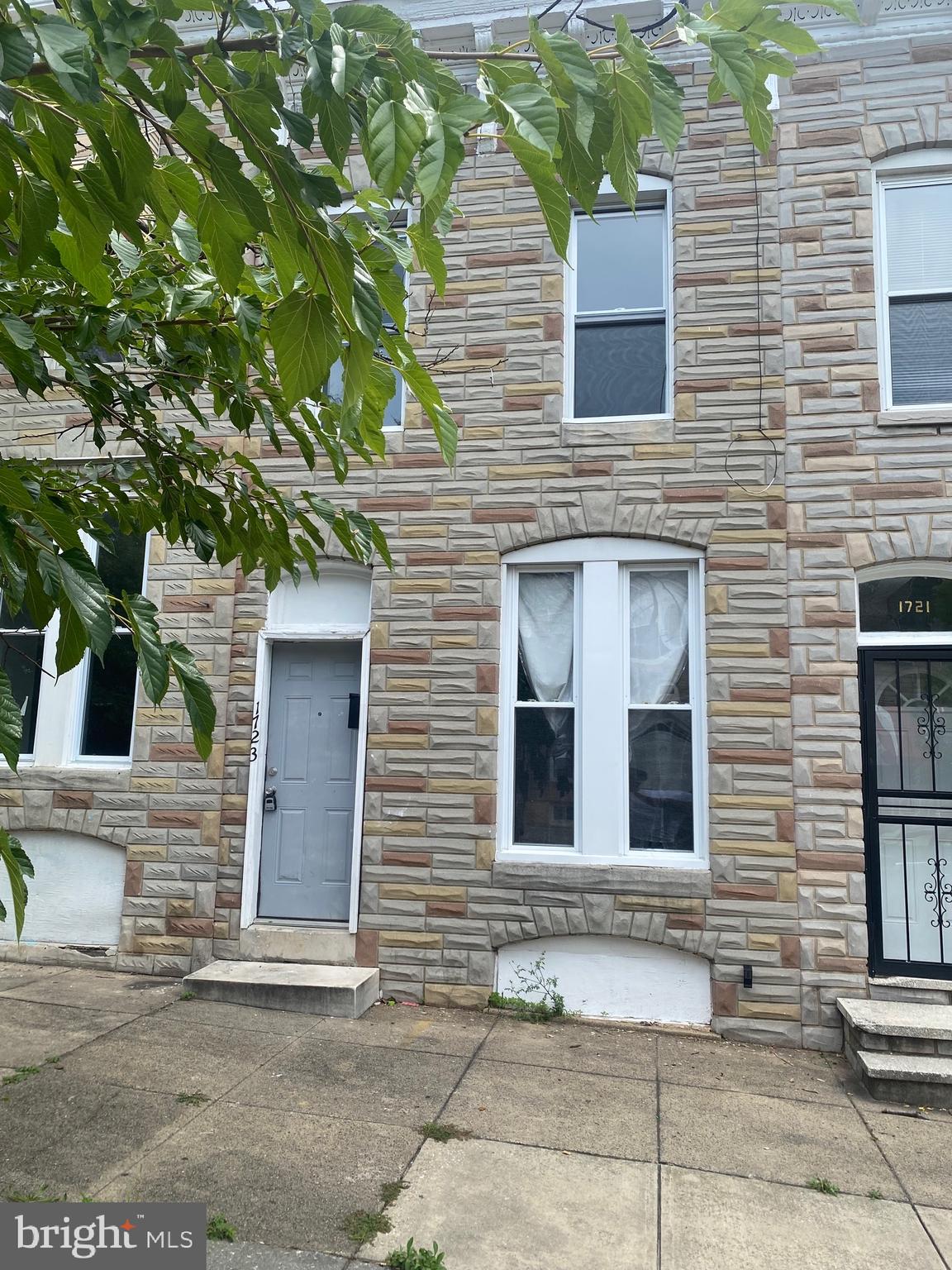 a view of a brick house with a large windows