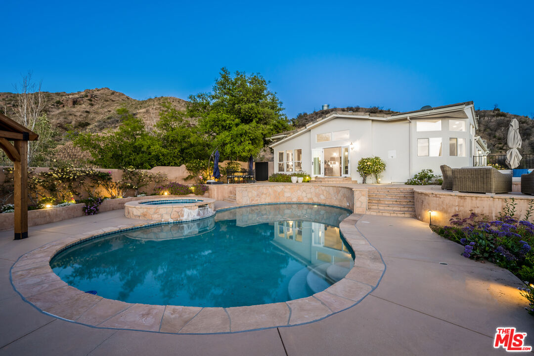 a view of a house with pool and a yard