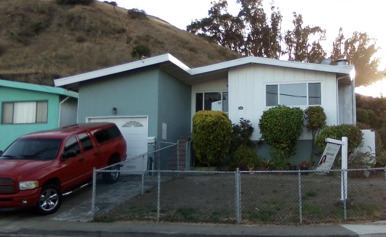 a view of backyard with outdoor seating and car parked