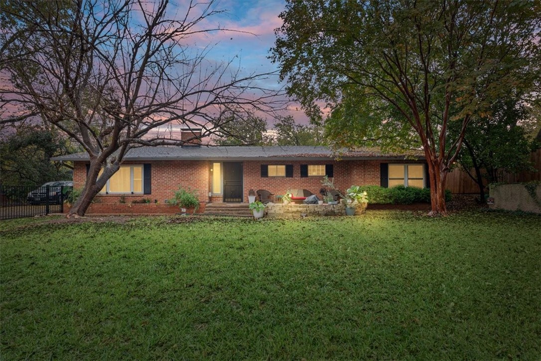 a front view of a house with yard patio and green space