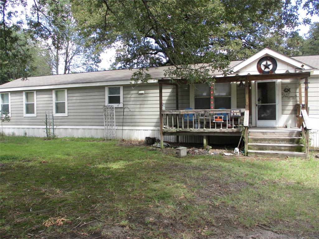 a view of a house with a yard porch and sitting area