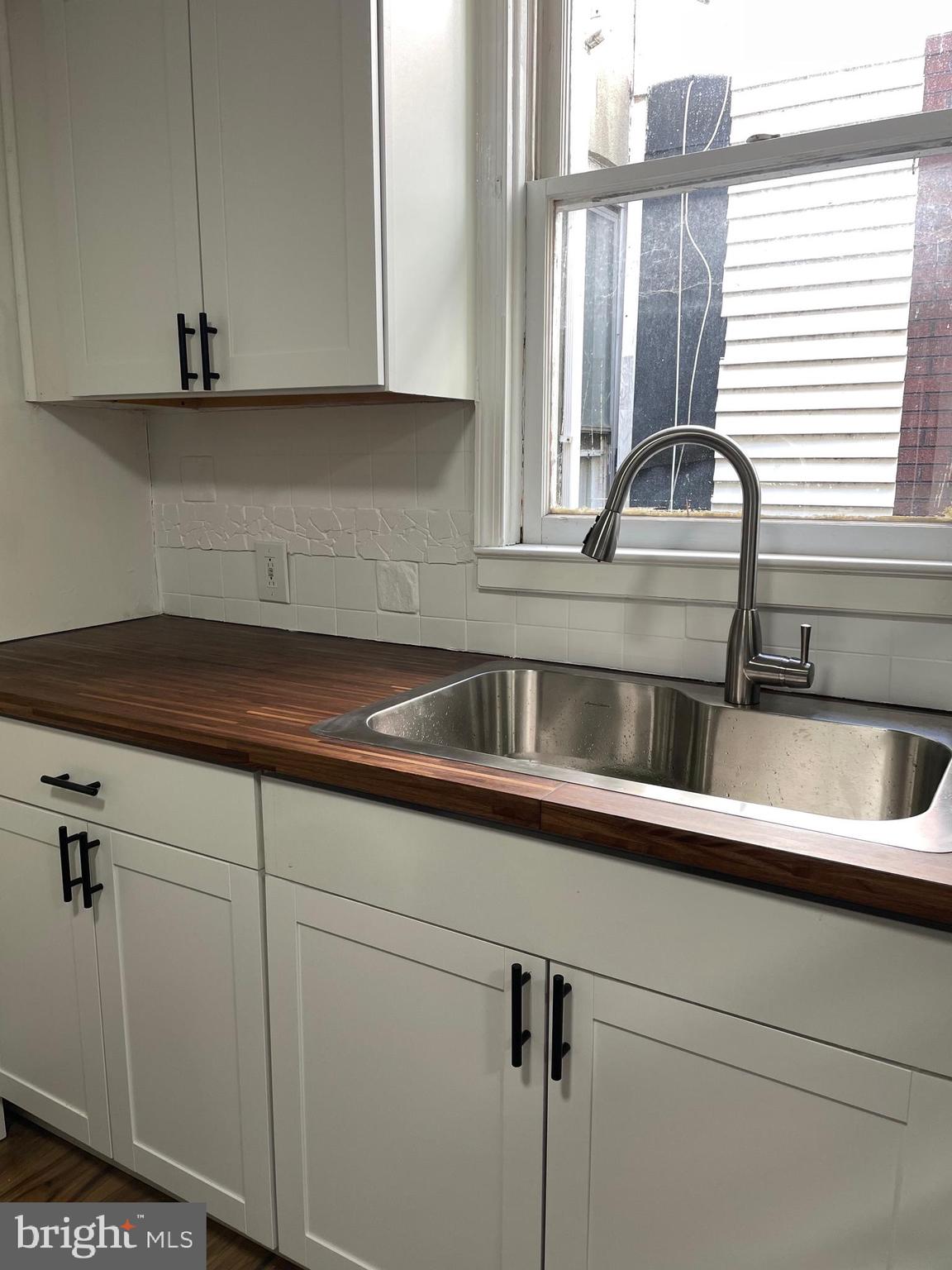 a kitchen with a sink and cabinets