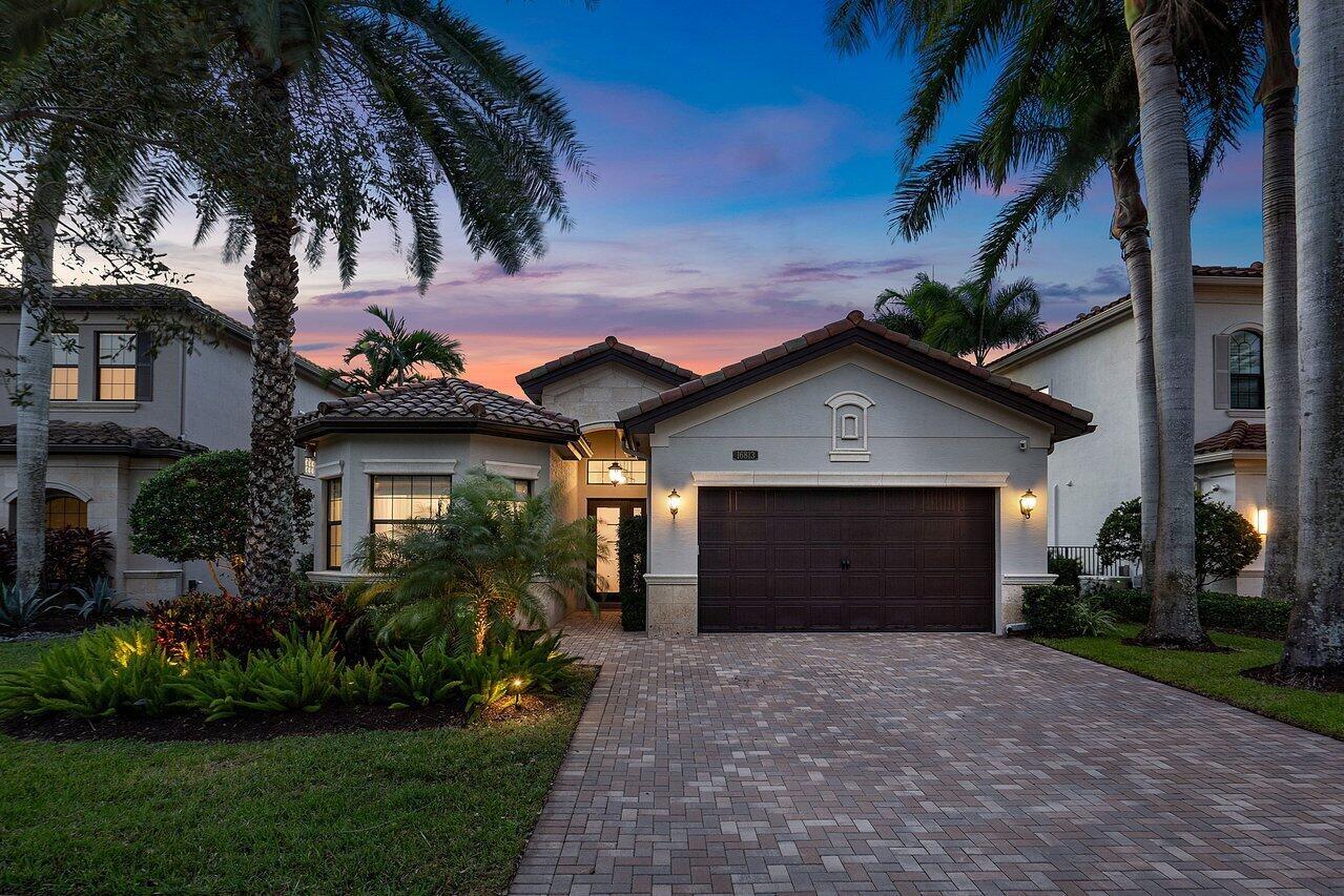 a front view of a house with a yard and garage