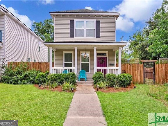 a front view of house with yard and green space