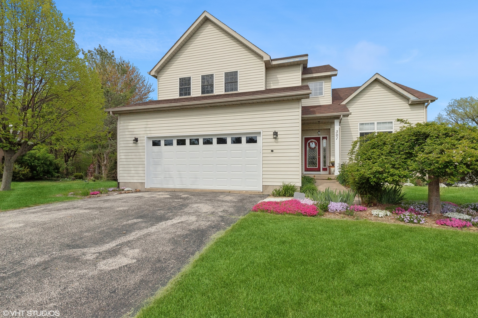 a front view of a house with a yard and garage