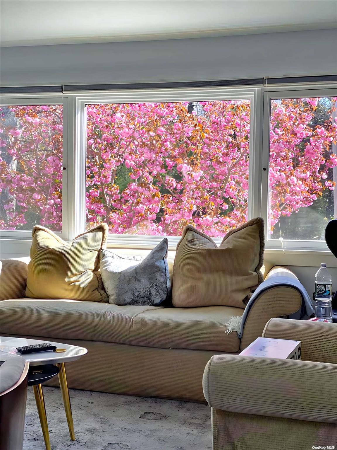 a living room with furniture and a painting on the wall