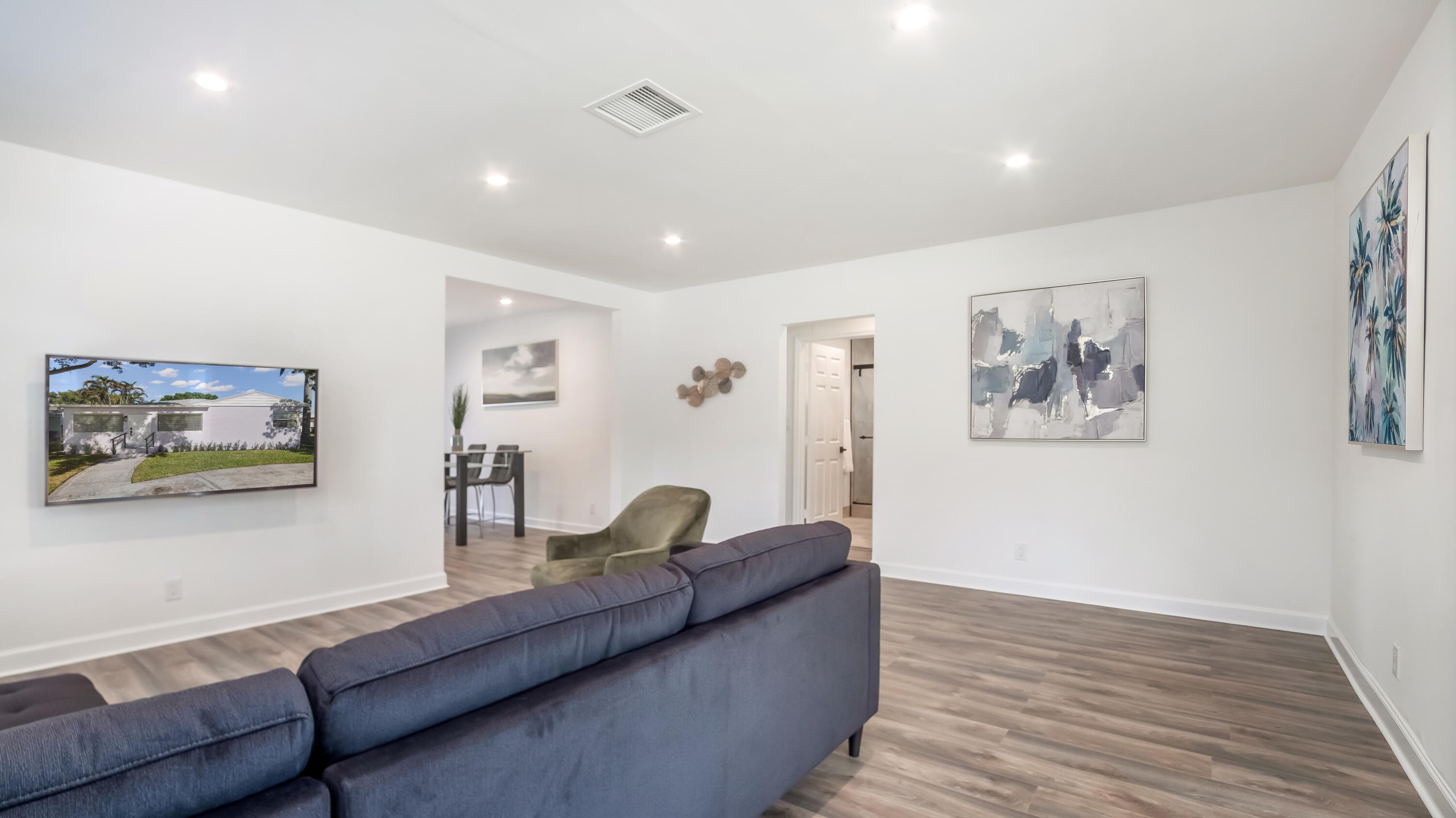 a living room with furniture and wooden floor