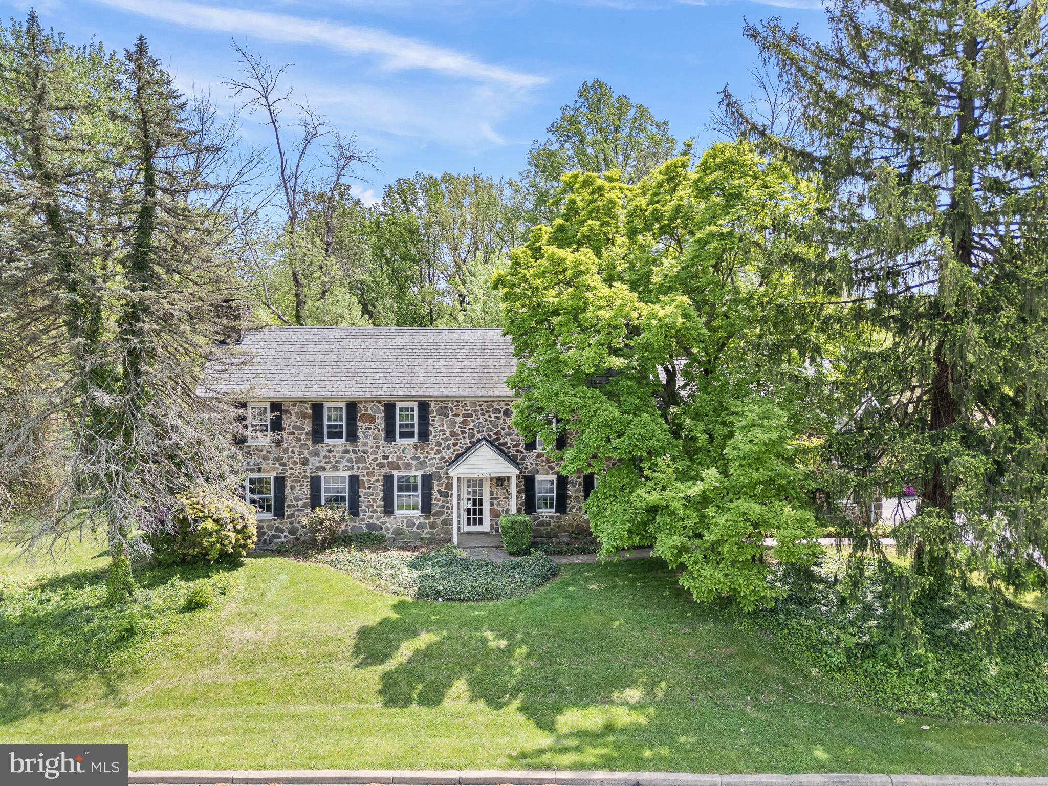 a view of a house with garden and trees