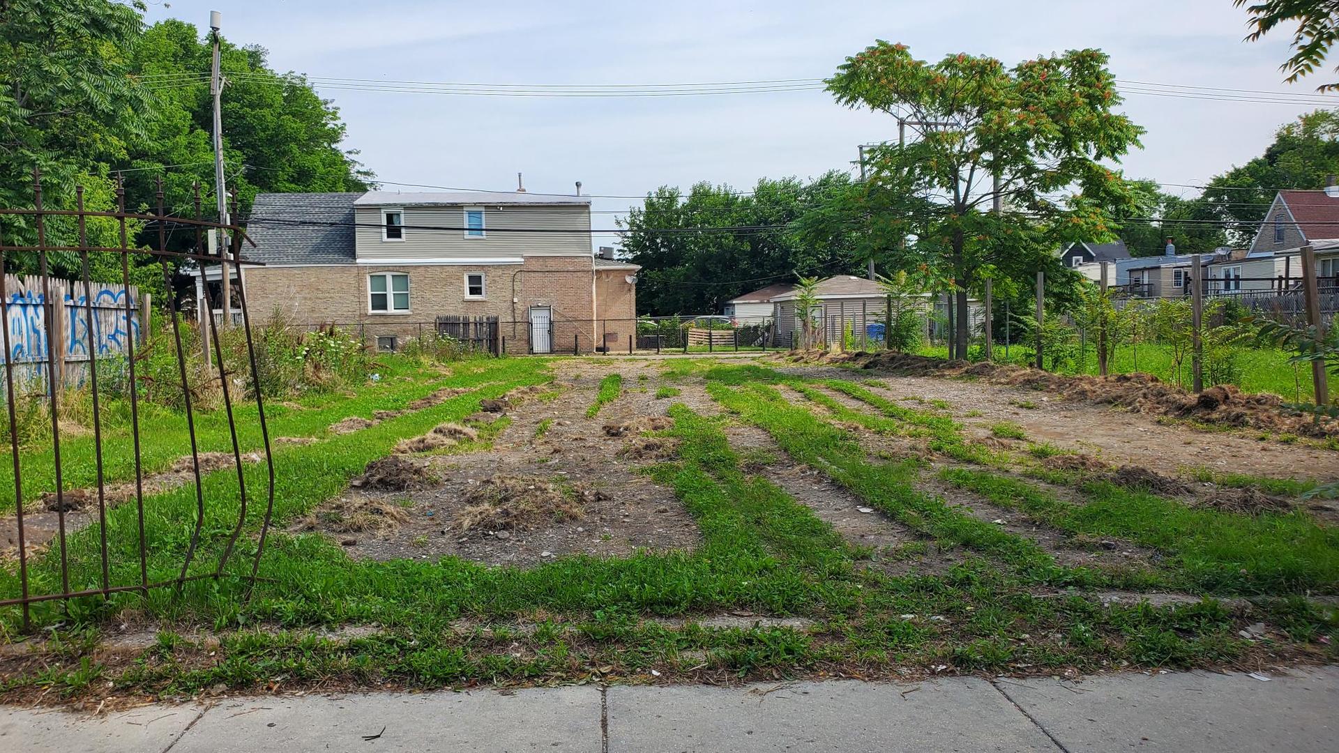 a view of a house with a backyard and a garden