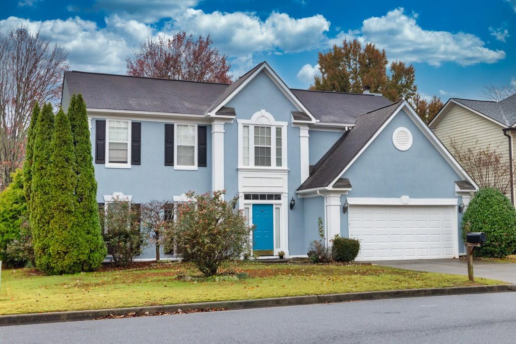 a front view of a house with a yard and garage