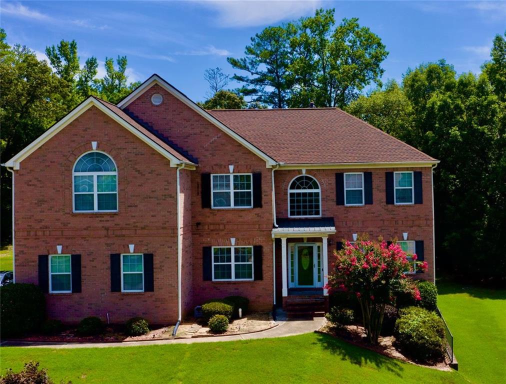 a front view of a house with a yard