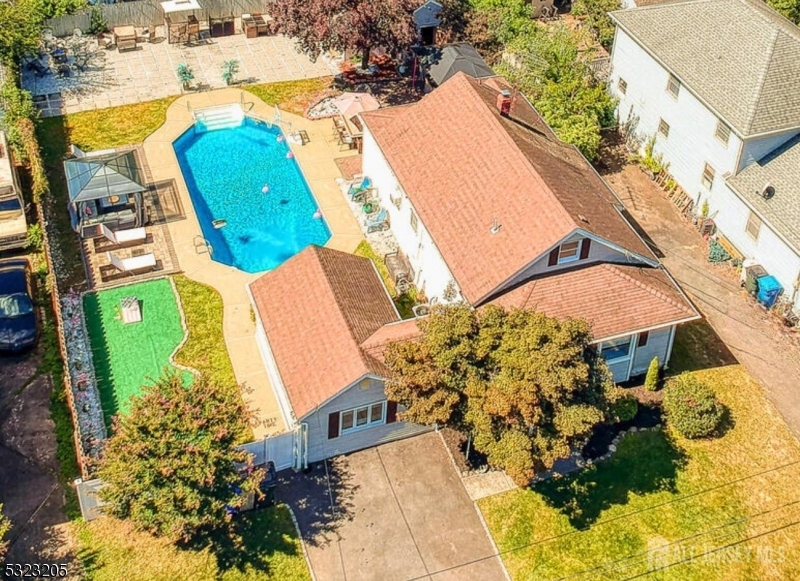 an aerial view of a house with a swimming pool