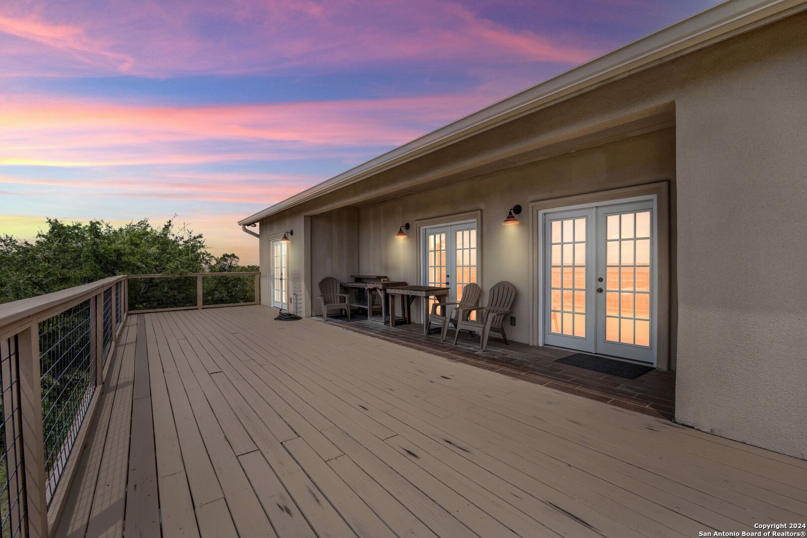 a view of a deck with wooden floor and a potted plant