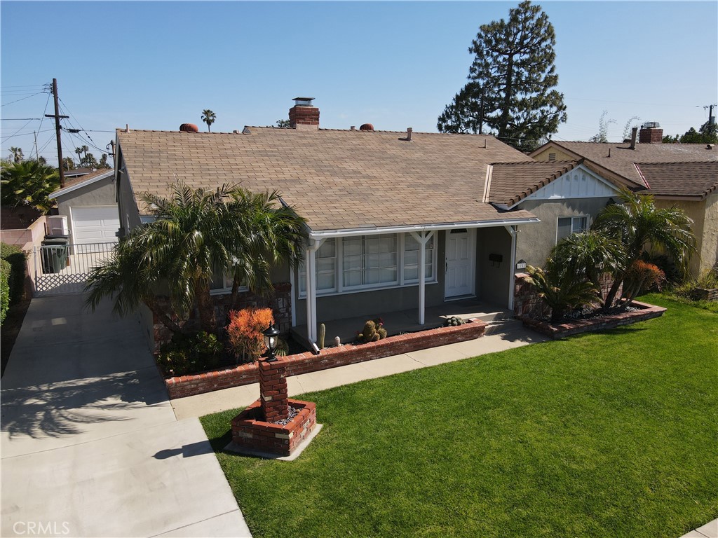 a front view of house with yard and outdoor seating