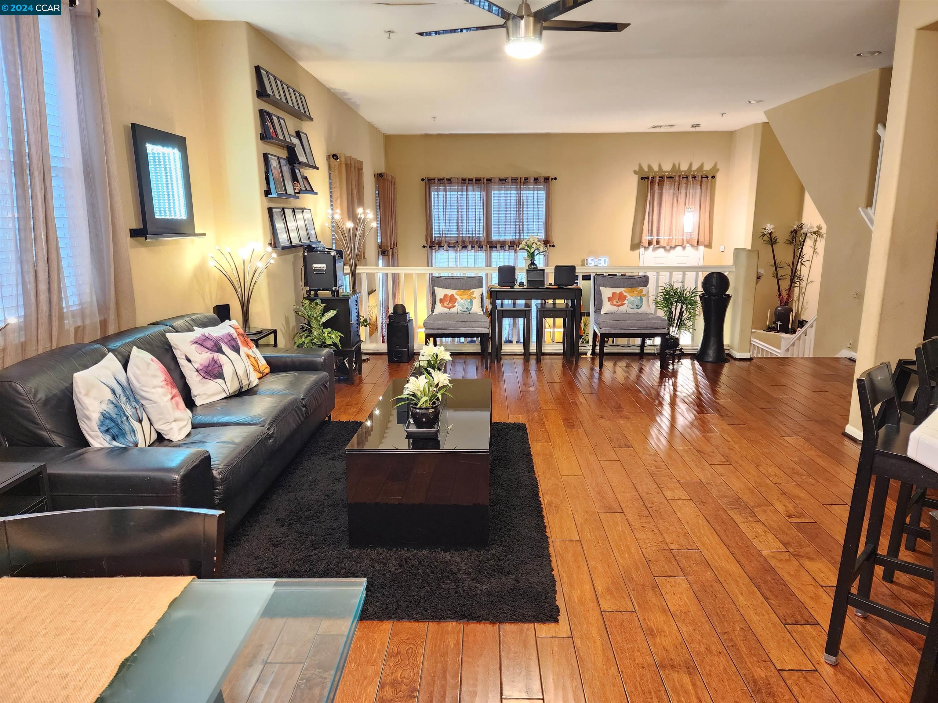 a living room with furniture and a dining table with kitchen view